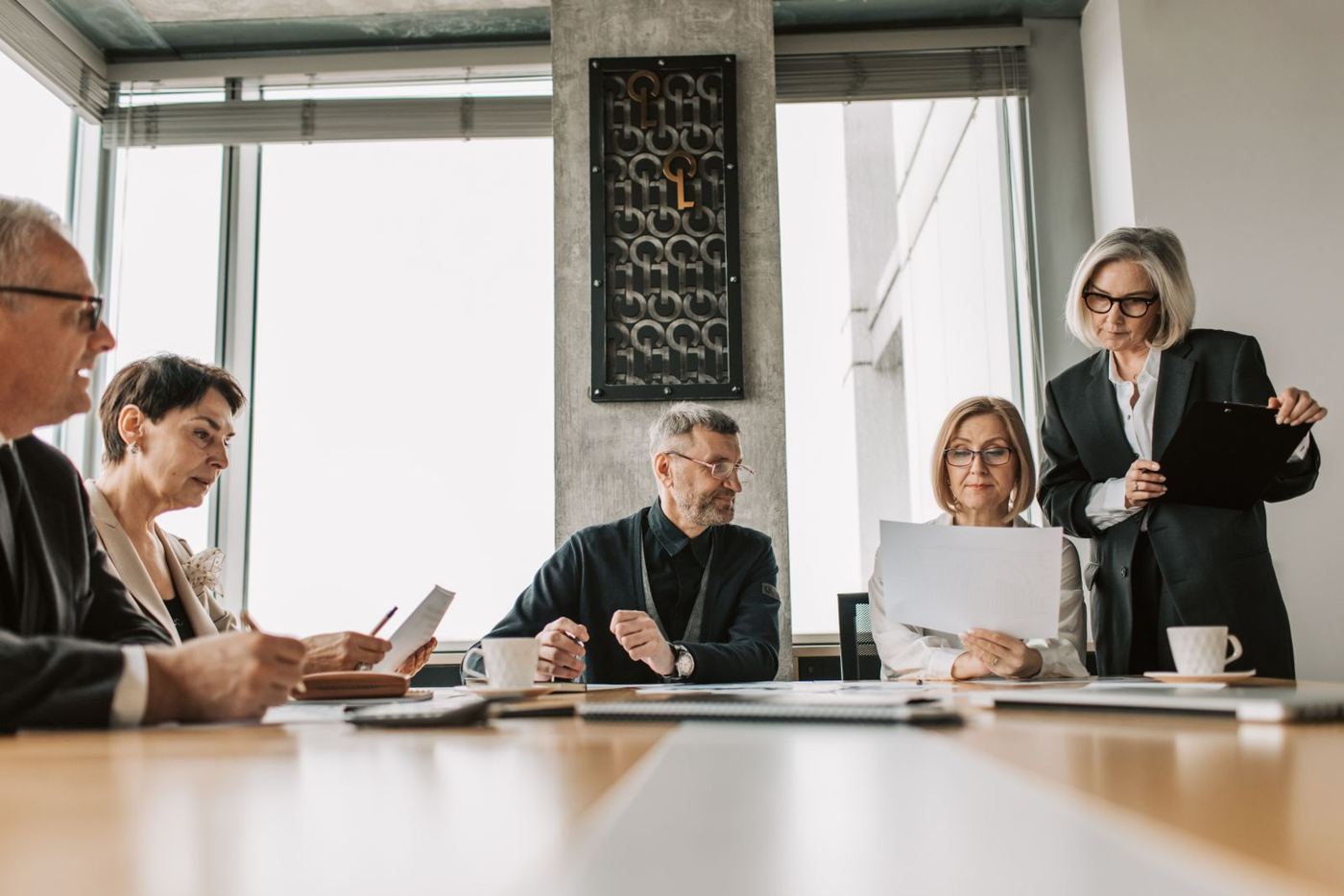 Executives reviewing documents around a conference table