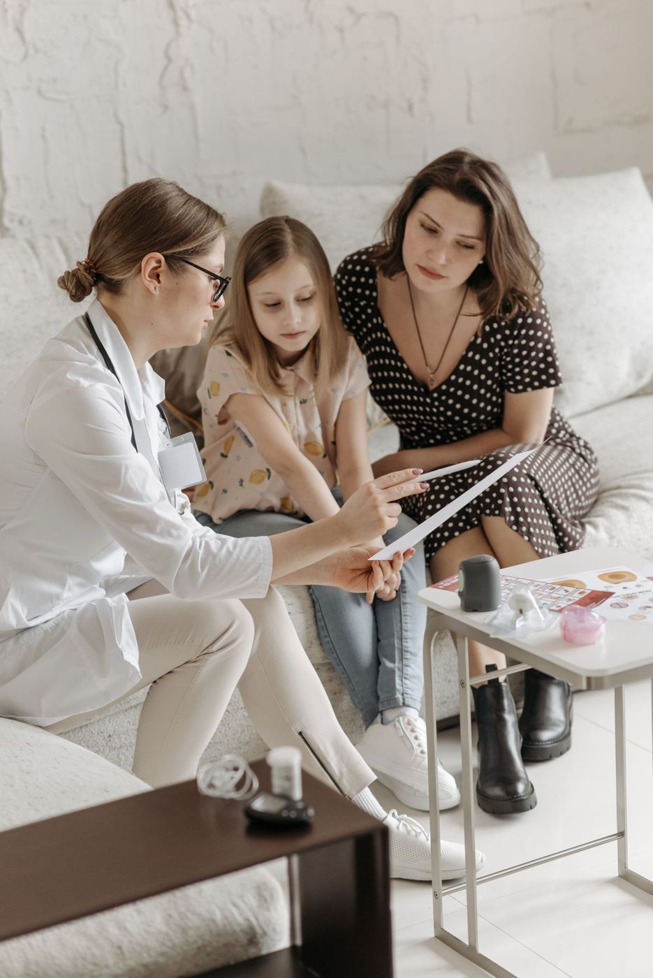A doctor talking with a mother and daughter